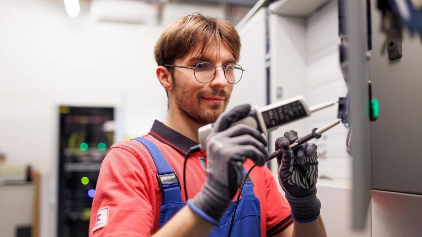 Techniker von Kaufland mit einem elektrischen Prüfgerät.
